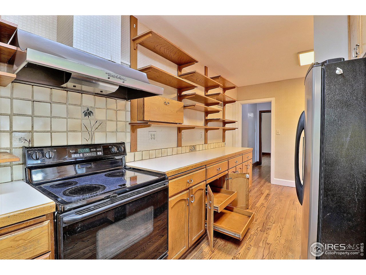 1607 Fairacre Drive Greeley, CO 80631 - Photo 14 of 40 a kitchen with stainless steel appliances granite countertop a stove and a refrigerator