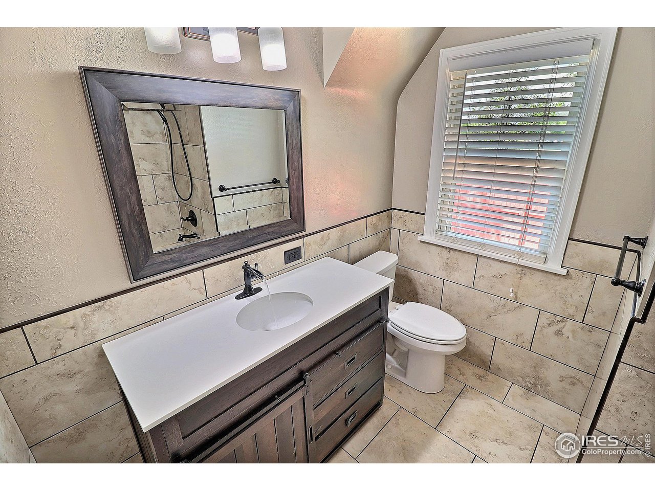 1607 Fairacre Drive Greeley, CO 80631 - Photo 19 of 40 a bathroom with a sink vanity mirror and toilet
