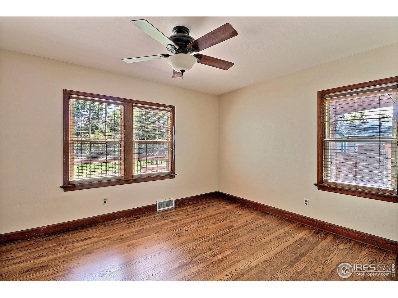 1607 Fairacre Drive Greeley, CO 80631 - Photo 20 of 40 a view of an empty room with wooden floor and a window