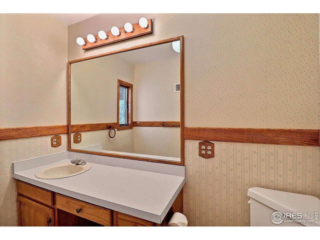 1607 Fairacre Drive Greeley, CO 80631 - Photo 22 of 40 a bathroom with a sink vanity and a mirror