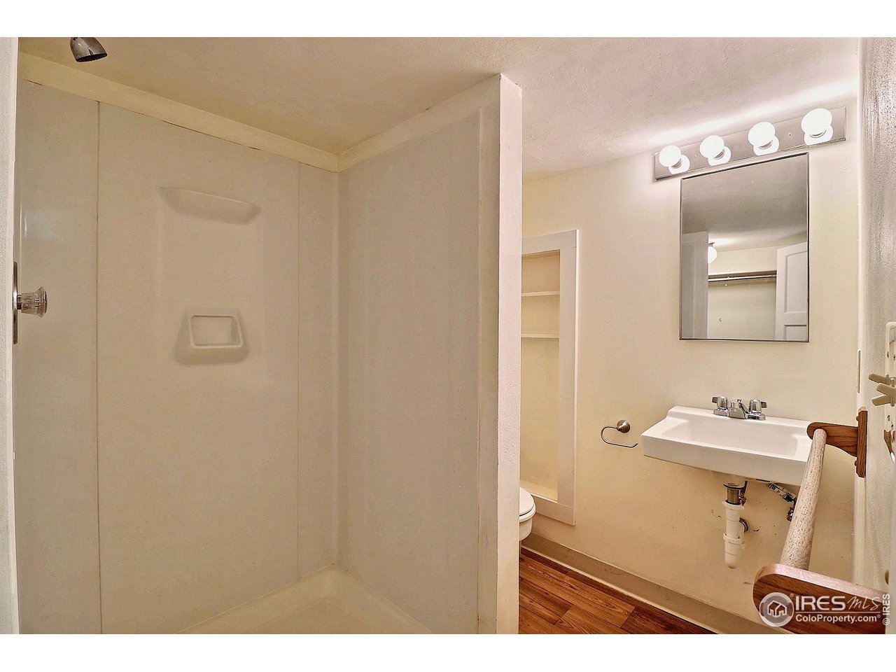 1607 Fairacre Drive Greeley, CO 80631 - Photo 32 of 40 a bathroom with a sink a toilet and mirror