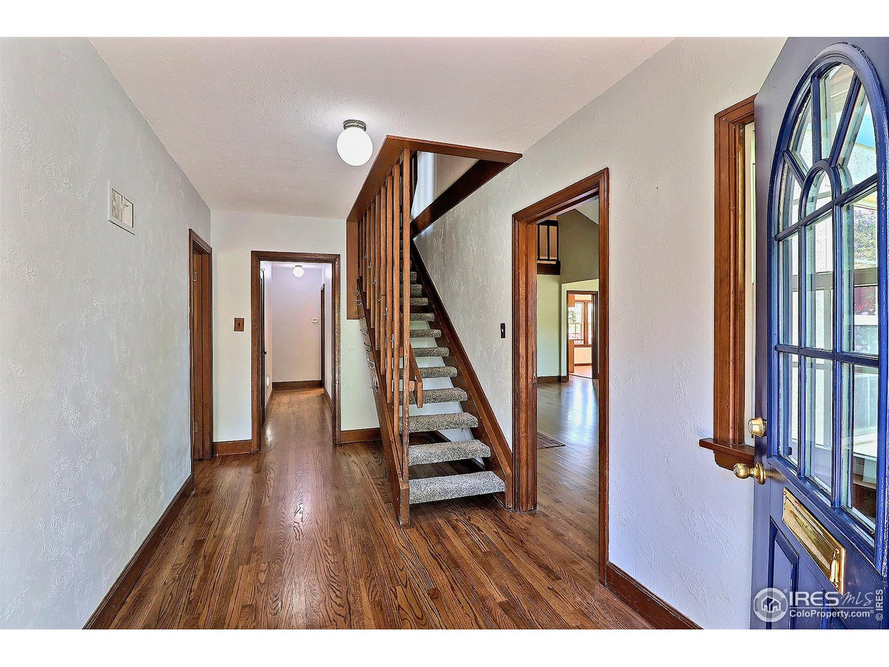 1607 Fairacre Drive Greeley, CO 80631 - Photo 4 of 40 a view of an entryway with wooden floor and stairs