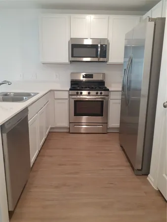 a kitchen with stainless steel appliances and wooden cabinets
