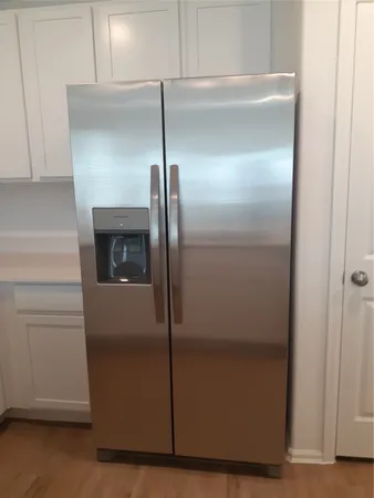 a kitchen with a refrigerator and cabinets