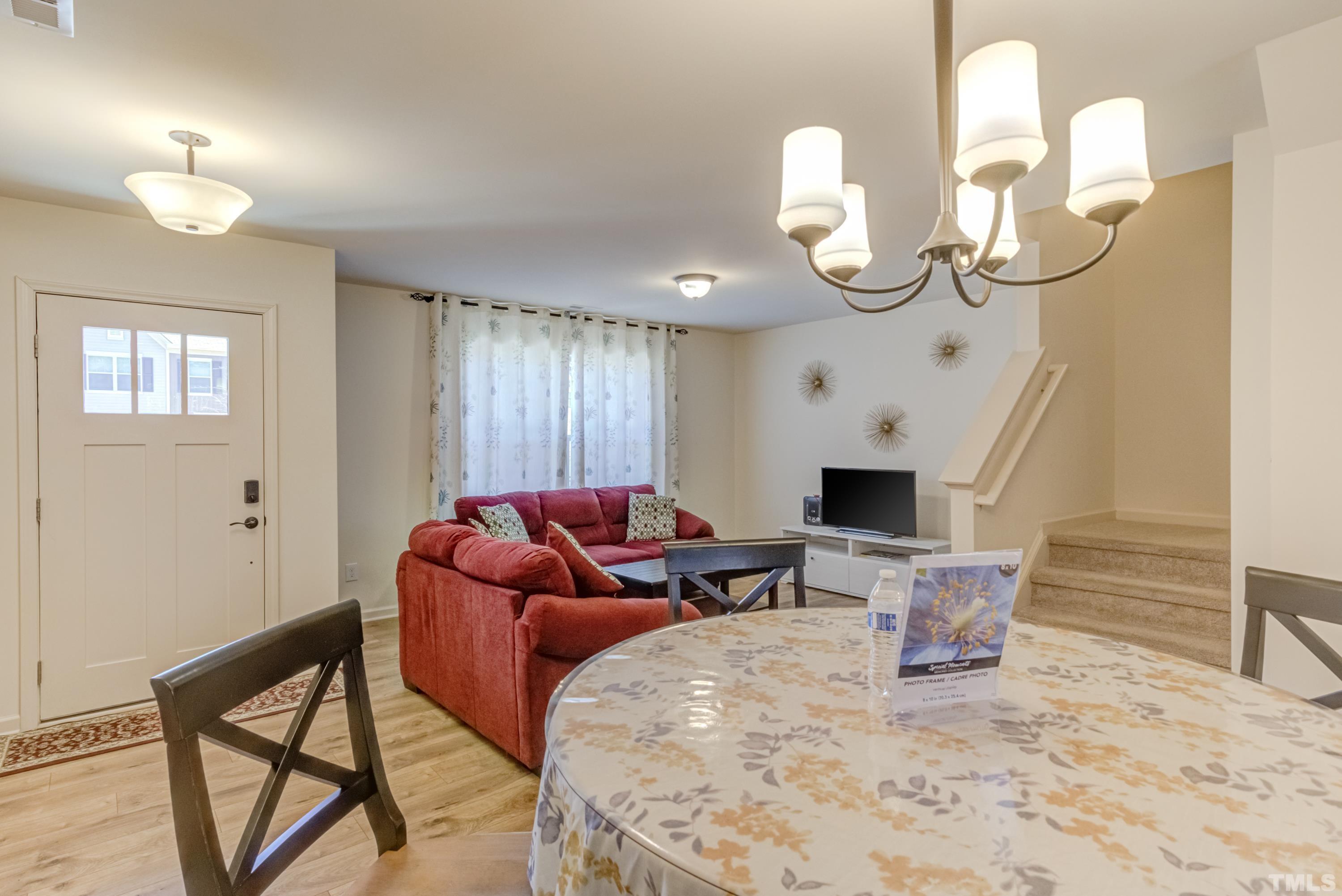 240 Spark Street Raleigh, NC 27606 - Photo 11 of 35 a living room with furniture chandelier and a fireplace