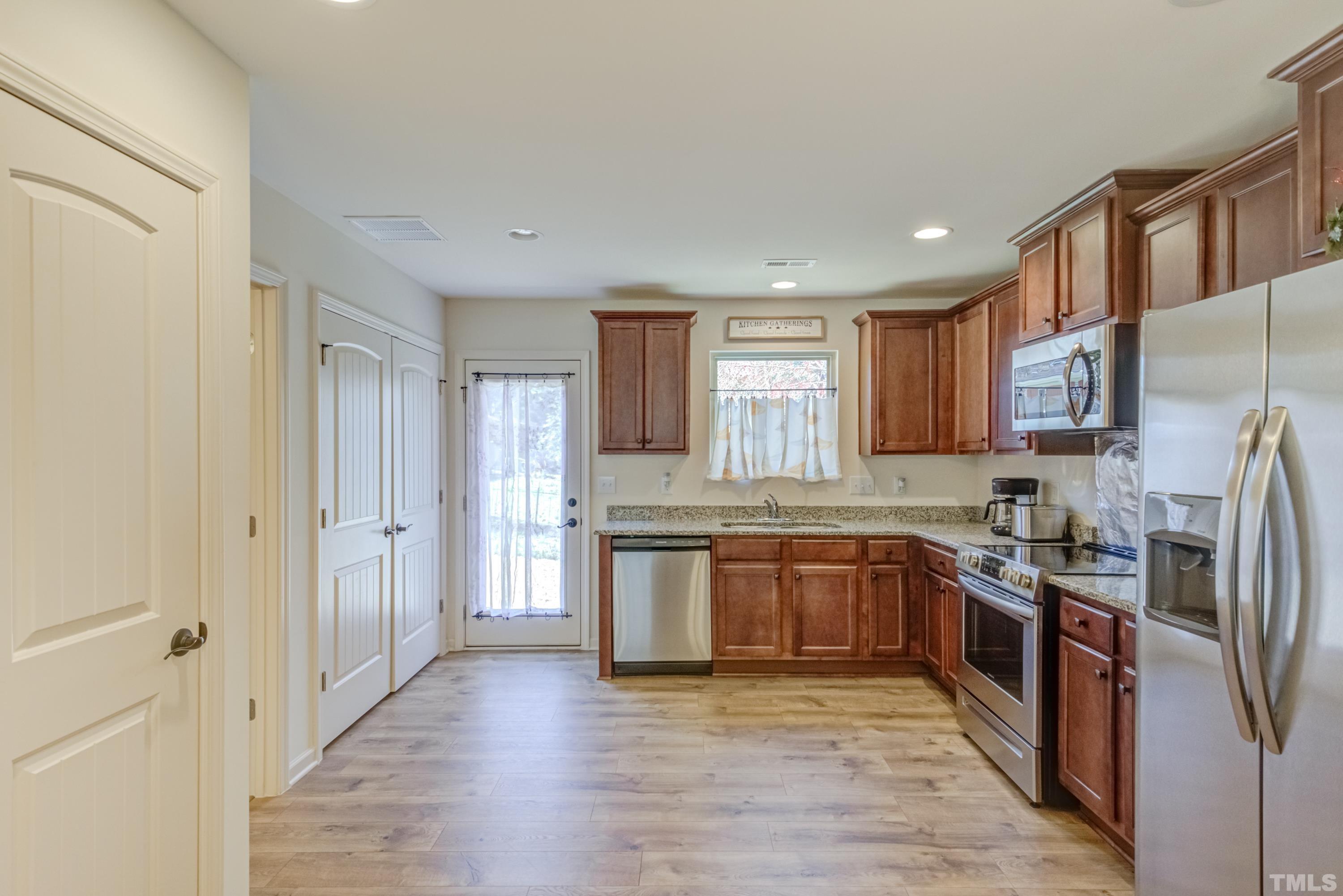 240 Spark Street Raleigh, NC 27606 - Photo 13 of 35 a large kitchen with stainless steel appliances granite countertop a stove and a refrigerator