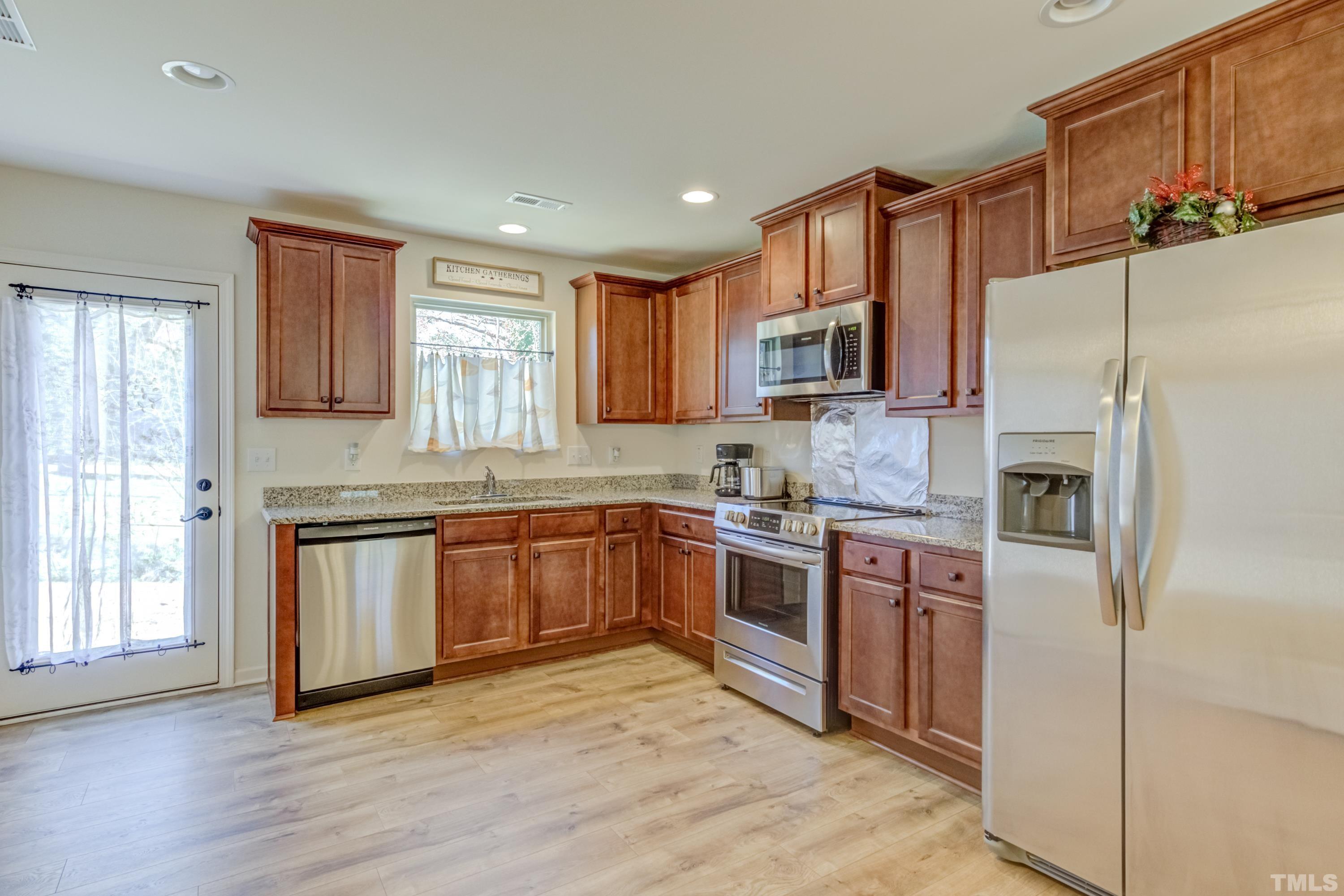 240 Spark Street Raleigh, NC 27606 - Photo 14 of 35 a kitchen with stainless steel appliances granite countertop a refrigerator stove top oven and sink
