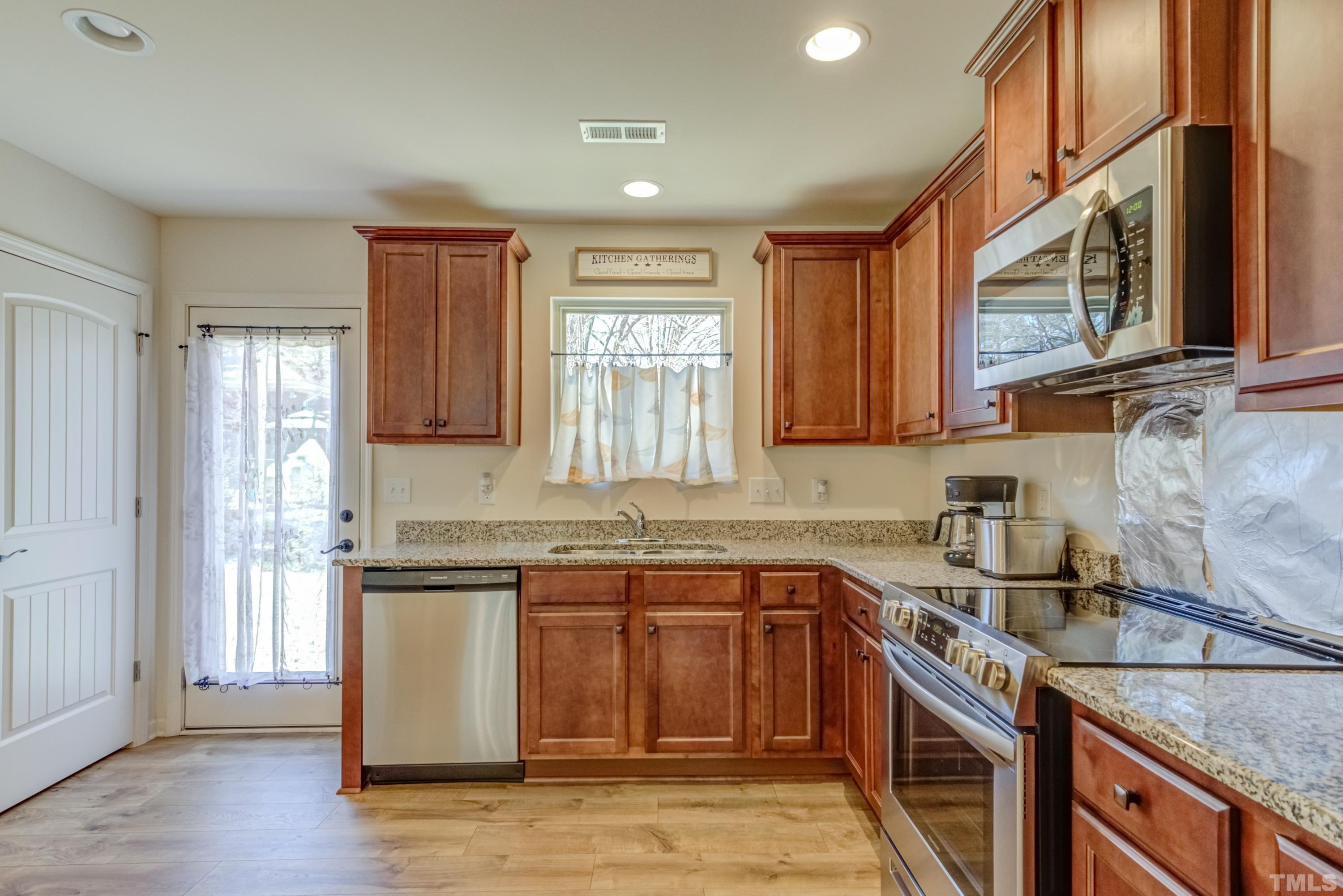240 Spark Street Raleigh, NC 27606 - Photo 16 of 35 a kitchen with stainless steel appliances granite countertop a sink stove and cabinets