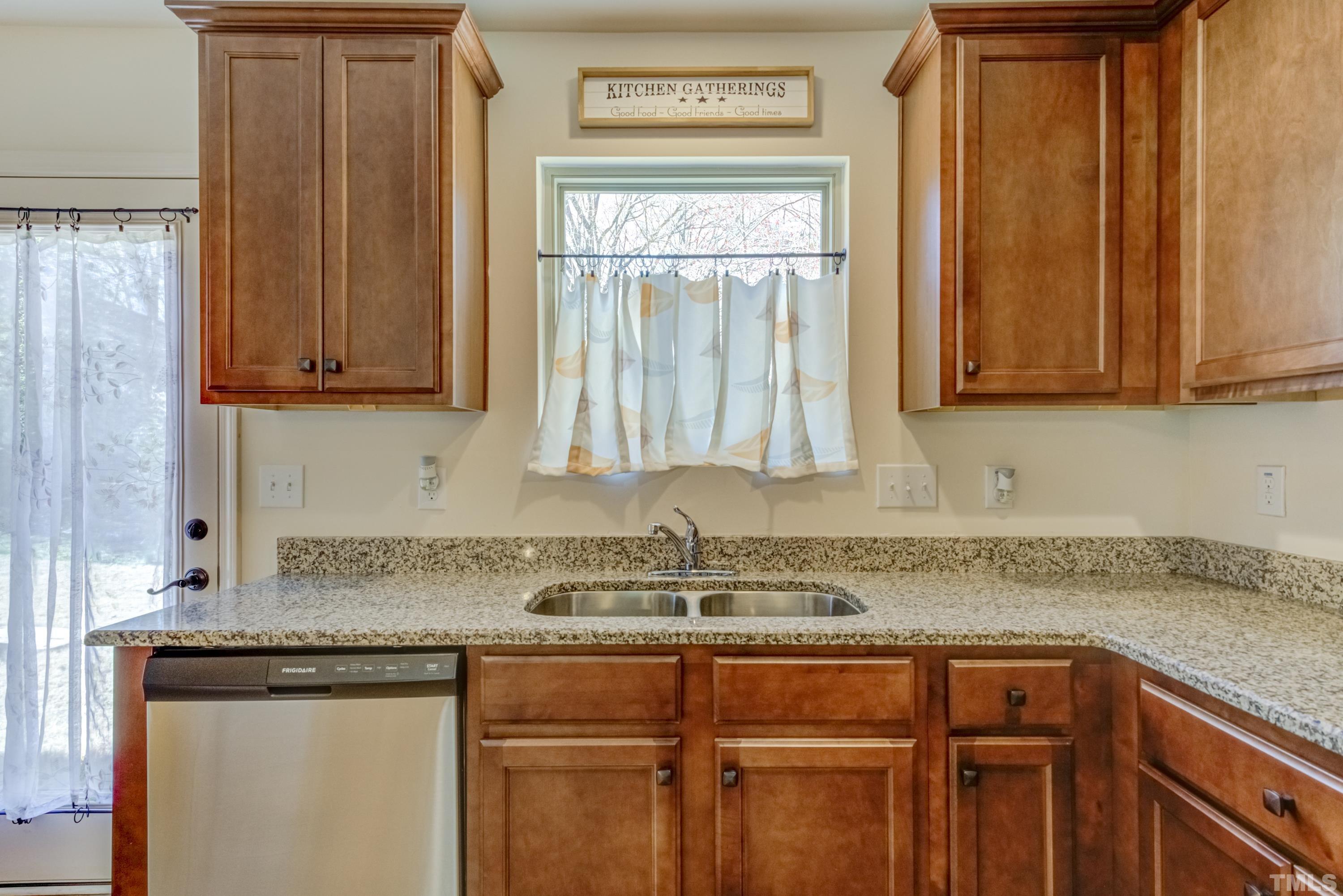 240 Spark Street Raleigh, NC 27606 - Photo 17 of 35 a kitchen with granite countertop cabinets sink and window
