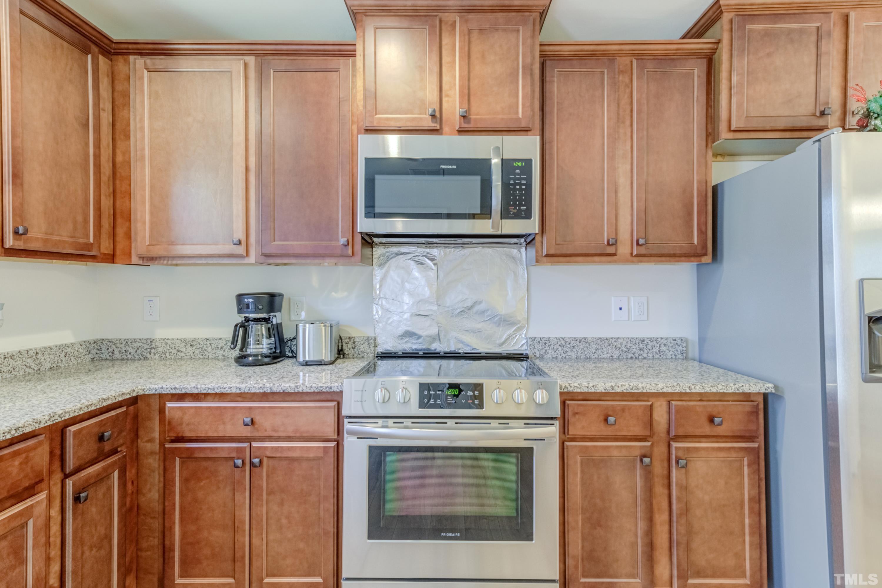 240 Spark Street Raleigh, NC 27606 - Photo 18 of 35 a kitchen with stainless steel appliances granite countertop a stove a sink and a microwave