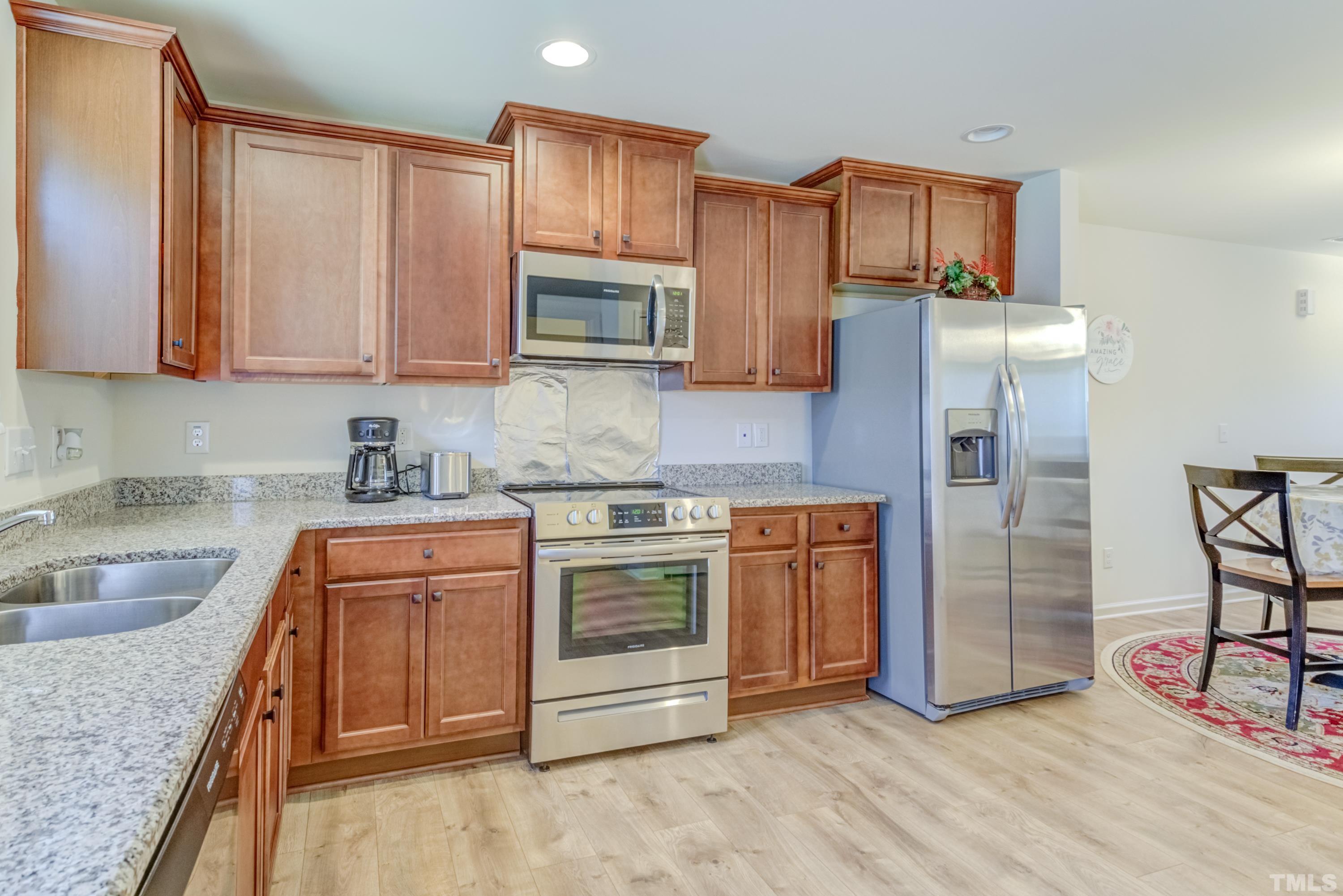 240 Spark Street Raleigh, NC 27606 - Photo 19 of 35 a kitchen with stainless steel appliances granite countertop a sink stove and refrigerator