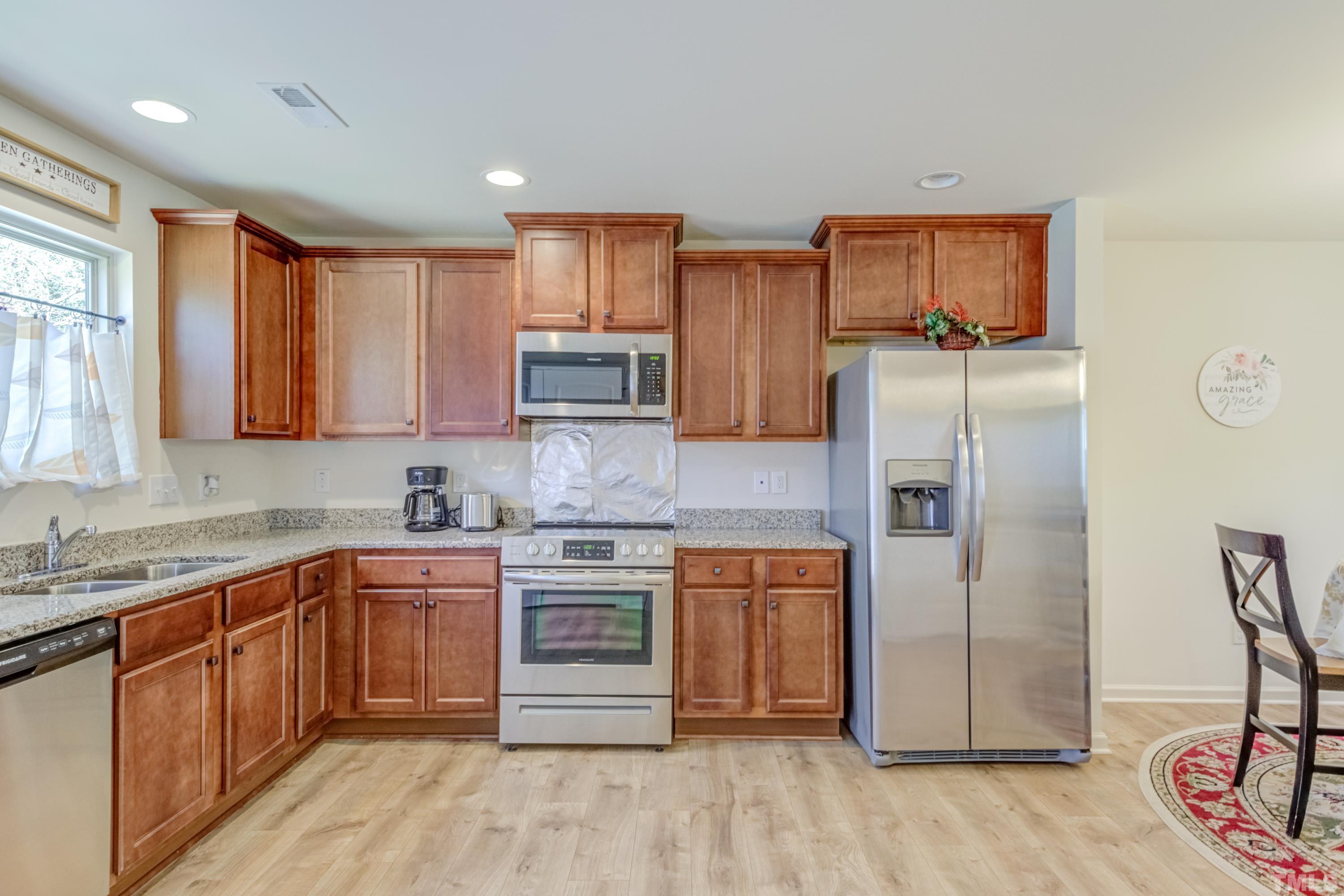 240 Spark Street Raleigh, NC 27606 - Photo 21 of 35 a kitchen with stainless steel appliances granite countertop a refrigerator sink and microwave