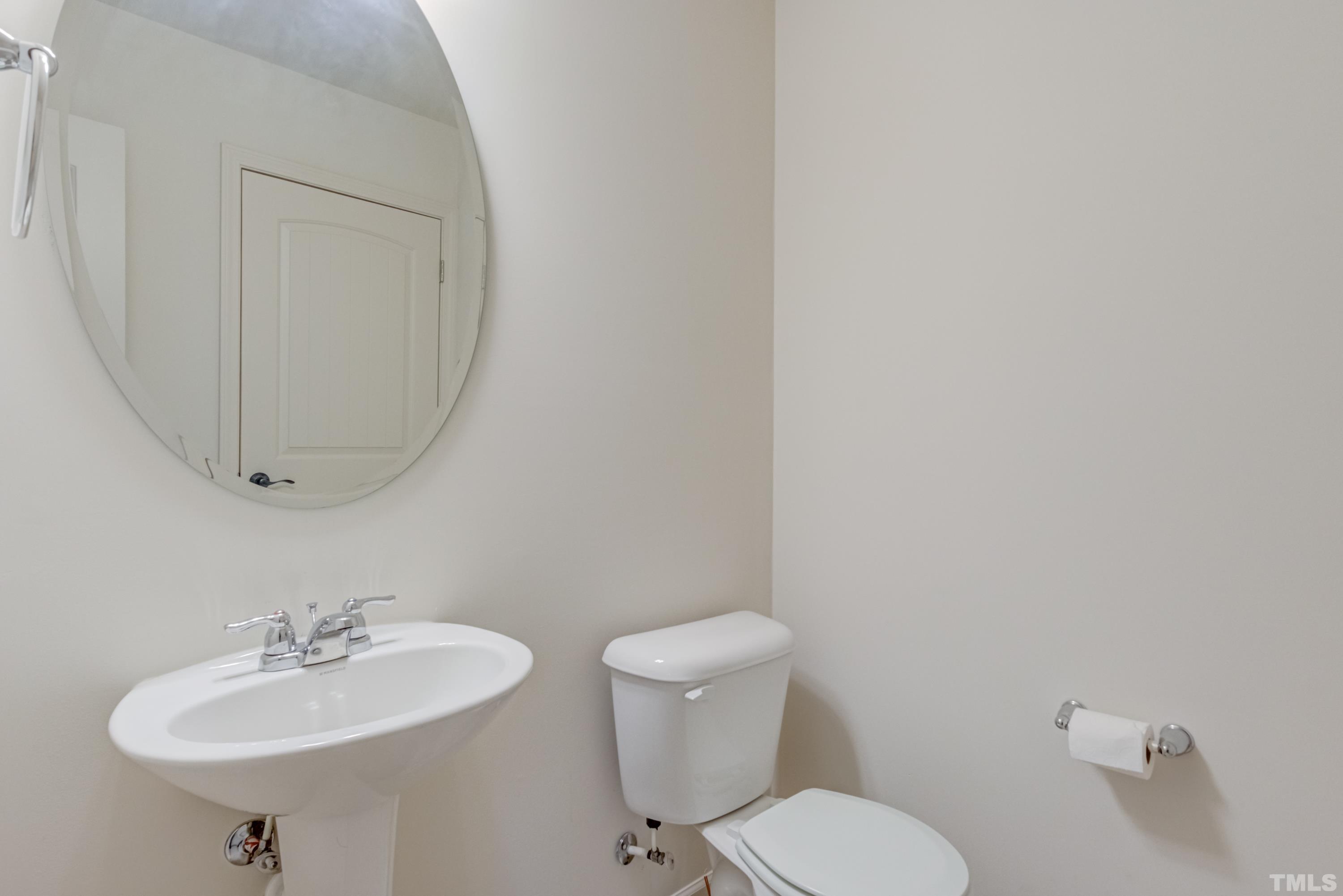 240 Spark Street Raleigh, NC 27606 - Photo 23 of 35 a bathroom with a sink a mirror and a toilet