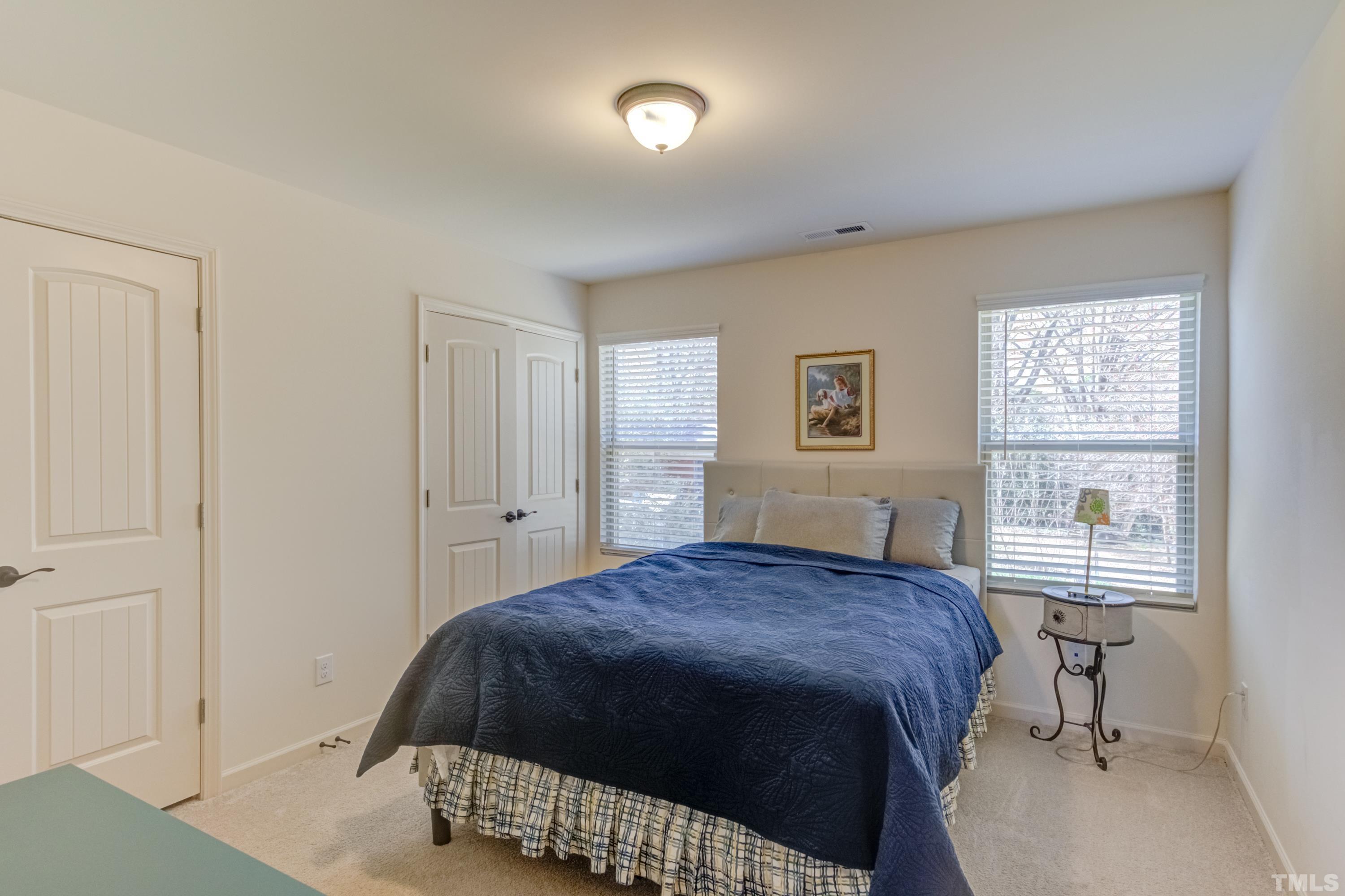 240 Spark Street Raleigh, NC 27606 - Photo 24 of 35 a bedroom with a bed and a table in it with window