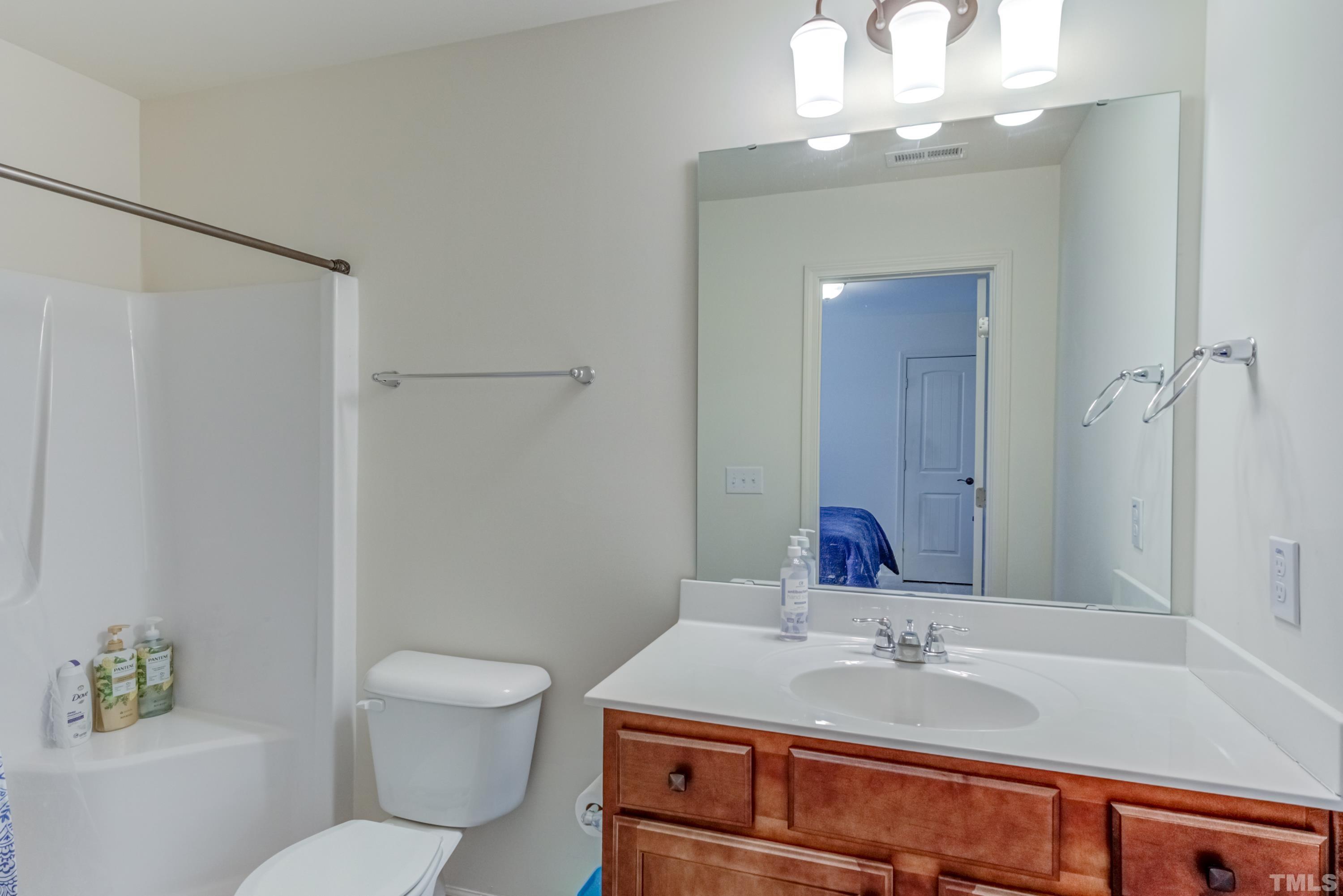 240 Spark Street Raleigh, NC 27606 - Photo 27 of 35 a bathroom with a sink a toilet and shower
