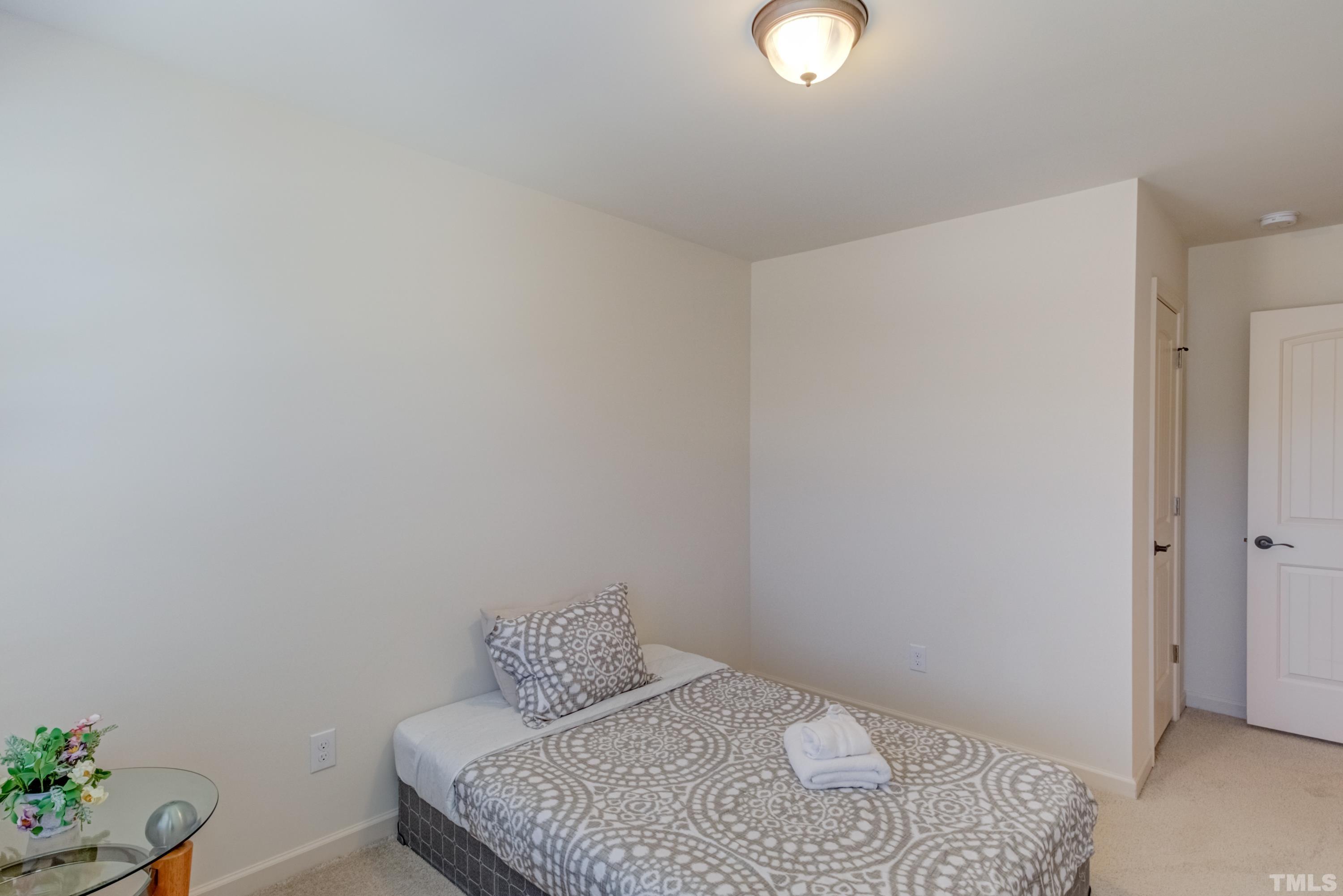 240 Spark Street Raleigh, NC 27606 - Photo 29 of 35 a bedroom with a bed and a potted plant