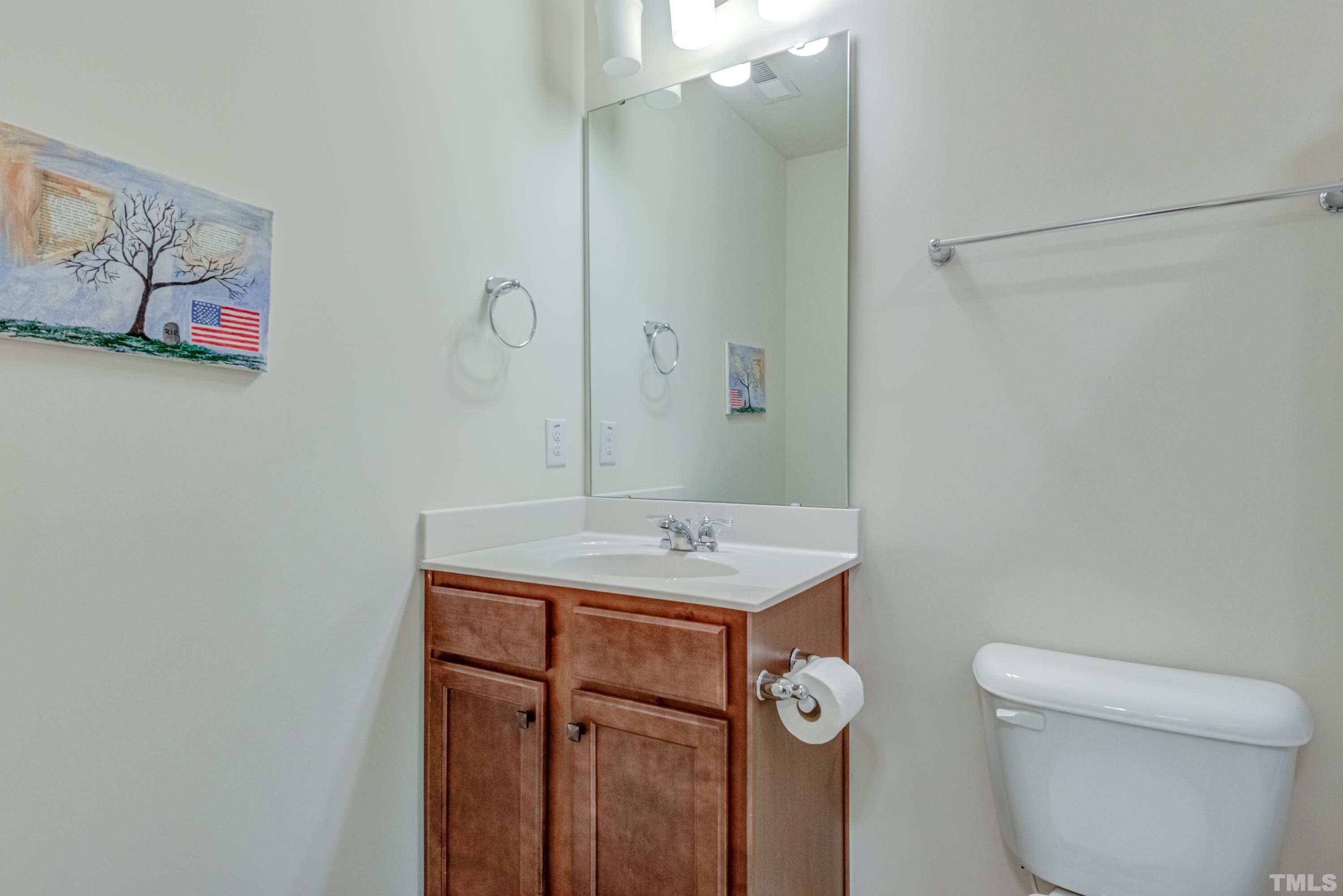 240 Spark Street Raleigh, NC 27606 - Photo 32 of 35 a bathroom with a toilet sink and mirror