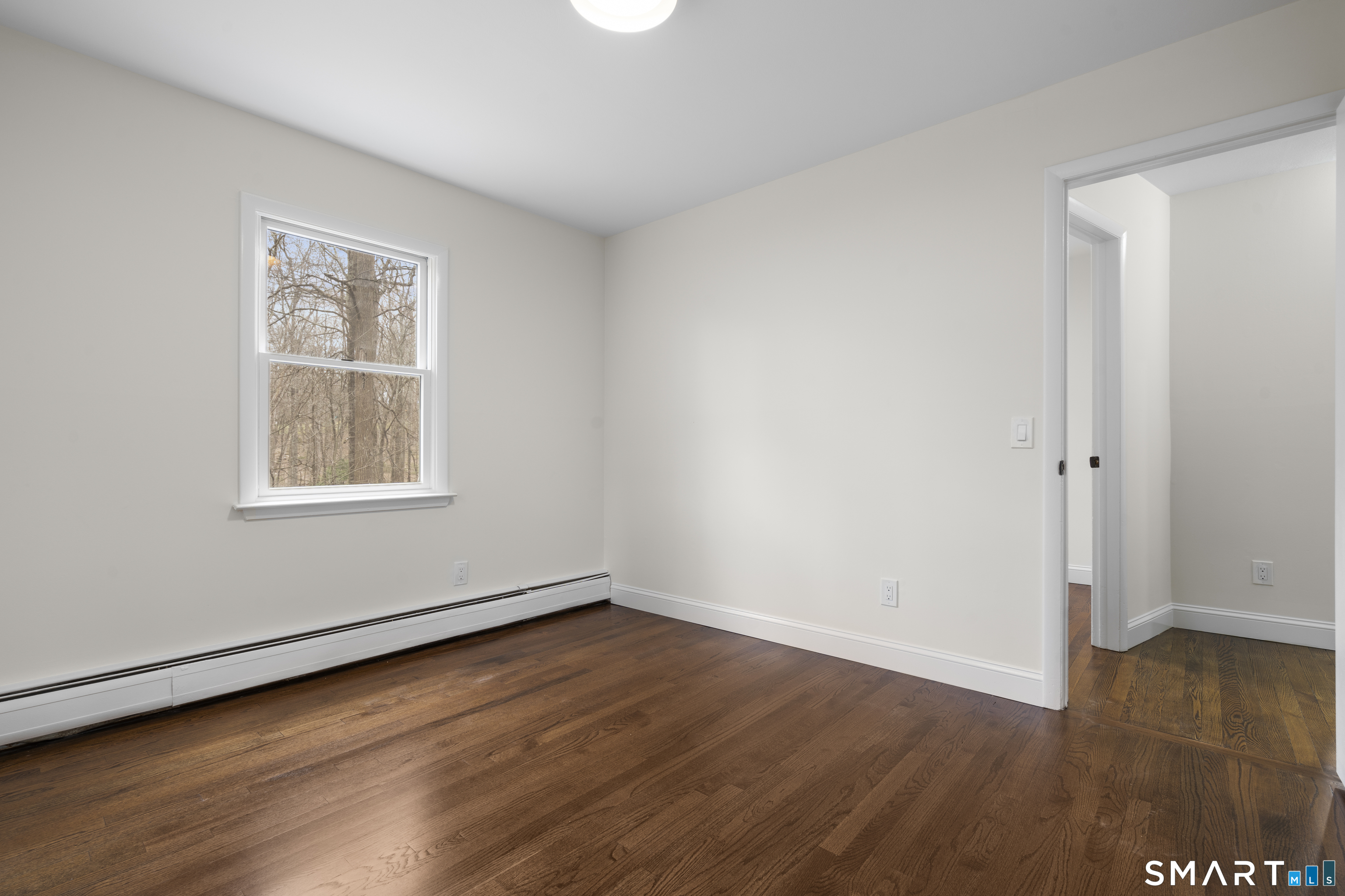 70 Dayton Road Redding, CT 06896 - Photo 17 of 38 an empty room with wooden floor and windows