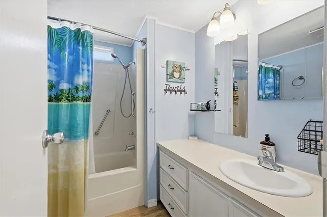 a bathroom with a bathtub shower sink and mirror