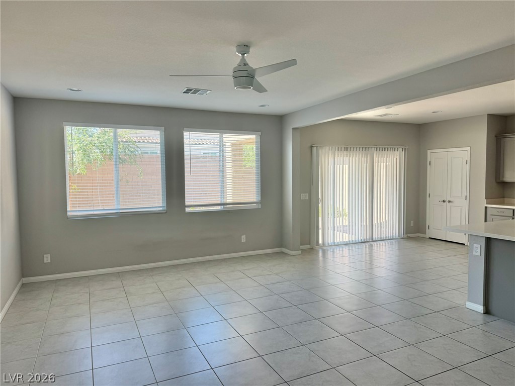 9953 Tucket Point Court Las Vegas, NV 89178 - Photo 4 of 22 A spacious common area with clean tile flooring flows into an adjacent kitchen.