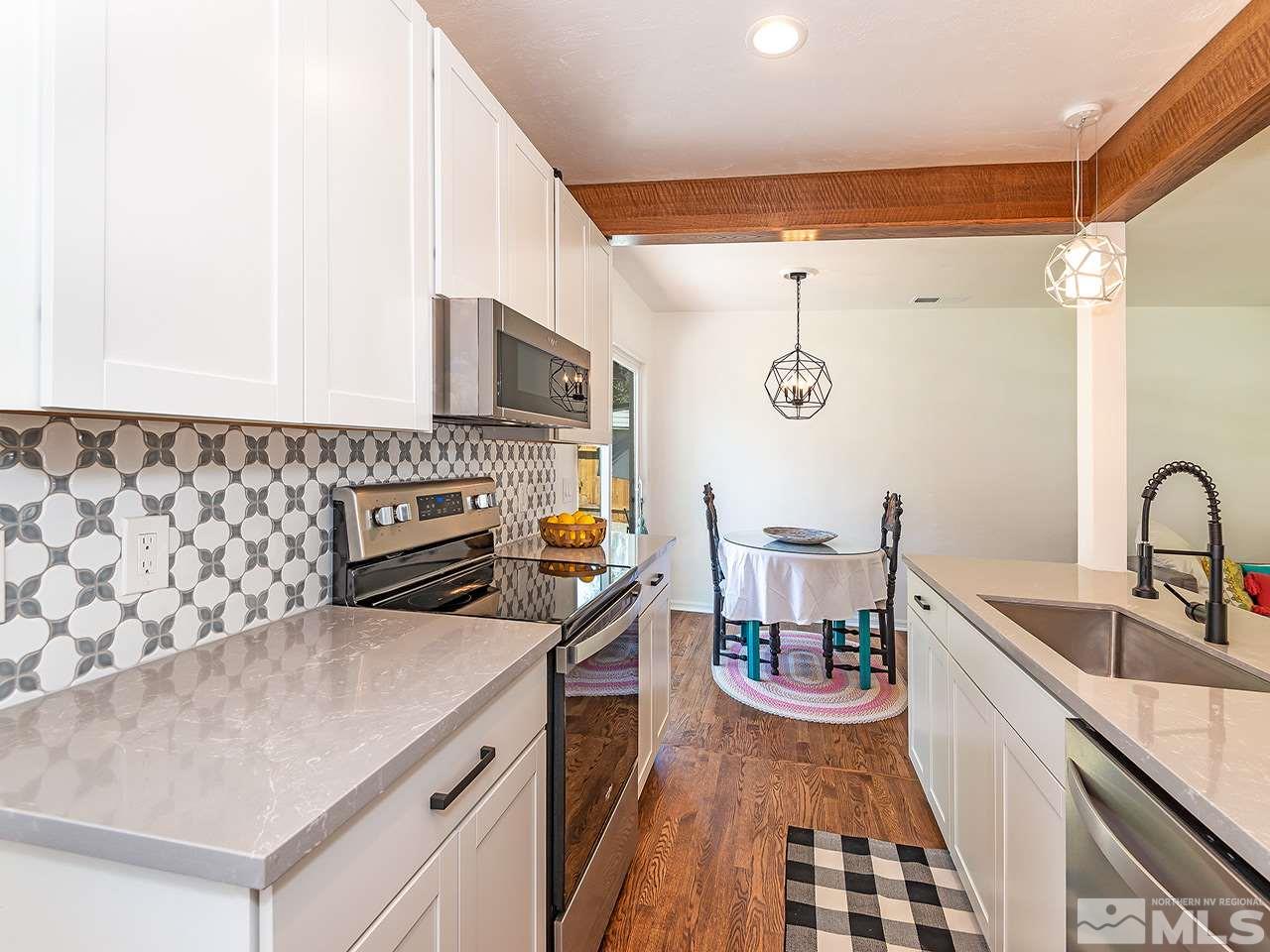 1055 Primrose Street Reno, NV 89509 - Photo 11 of 26 a kitchen with stainless steel appliances a stove a sink and a refrigerator