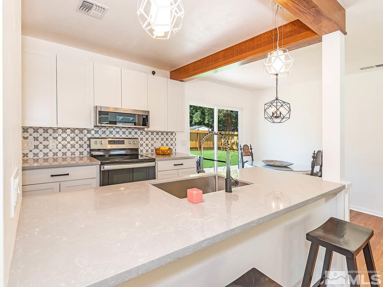 1055 Primrose Street Reno, NV 89509 - Photo 12 of 26 a kitchen with a sink a stove and cabinets