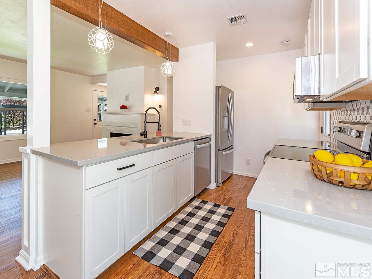1055 Primrose Street Reno, NV 89509 - Photo 13 of 26 a kitchen with a sink and a refrigerator