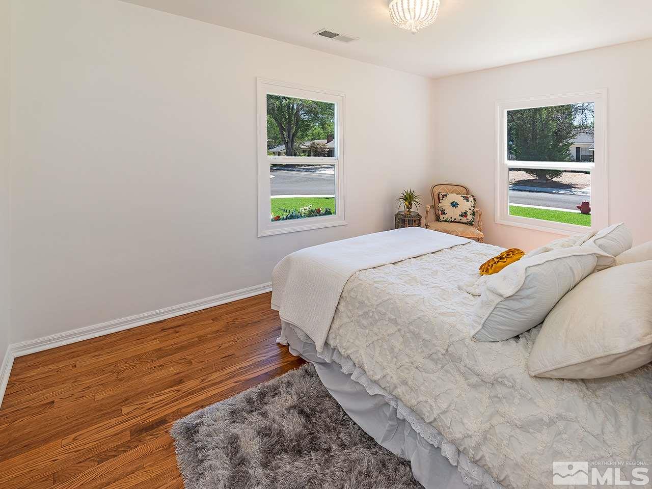 1055 Primrose Street Reno, NV 89509 - Photo 17 of 26 a bed sitting in a bedroom next to a window