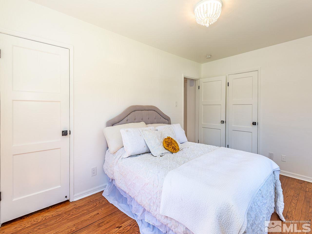 1055 Primrose Street Reno, NV 89509 - Photo 18 of 26 a bedroom with a bed and wooden floor