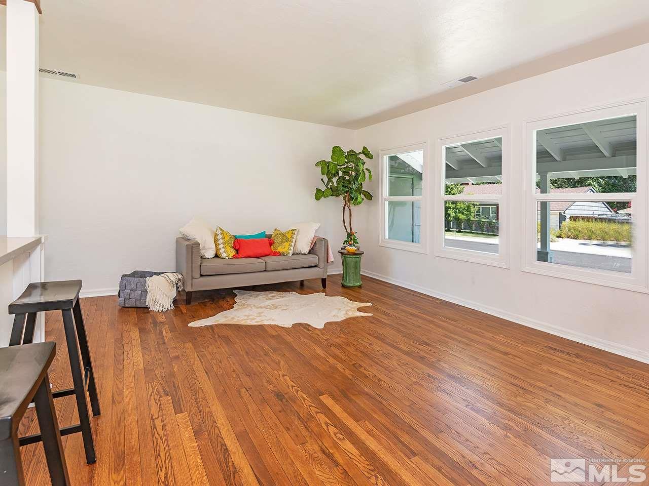 1055 Primrose Street Reno, NV 89509 - Photo 7 of 26 a living room with furniture and a potted plant next to a window