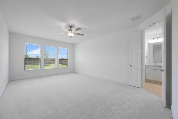 a view of a livingroom with furniture and a ceiling fan