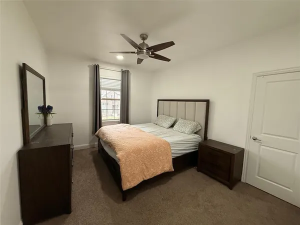 a view of a room with chandelier fan and windows