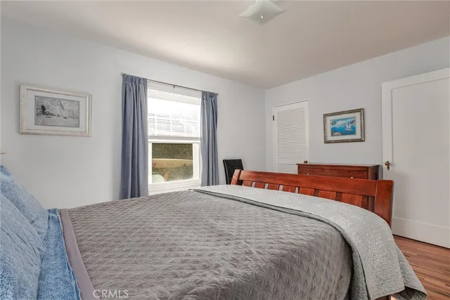 a bedroom with beds and a window