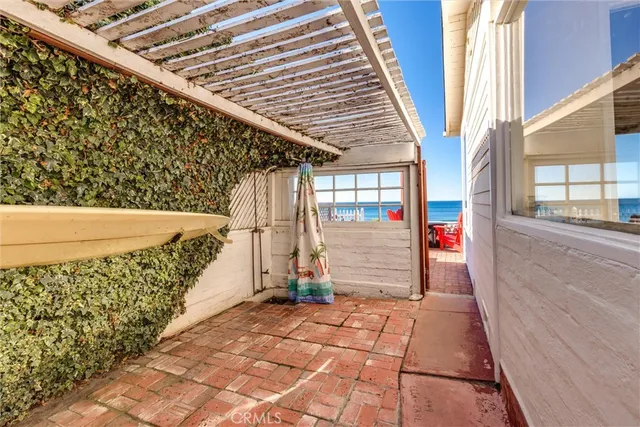 a view of a patio with table and chairs with wooden floor and plants