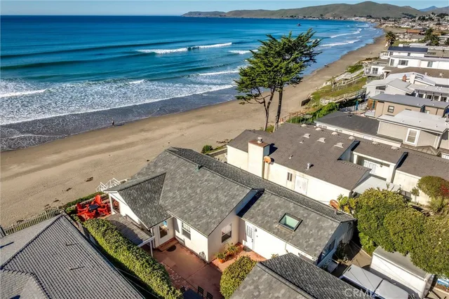 an aerial view of residential houses with outdoor space and seating