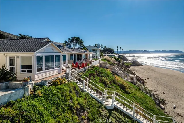 an aerial view of a building with garden space and ocean view