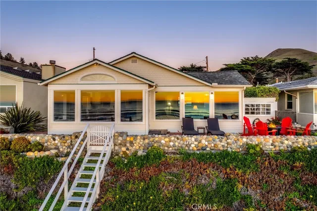 a front view of a house with a porch and a yard