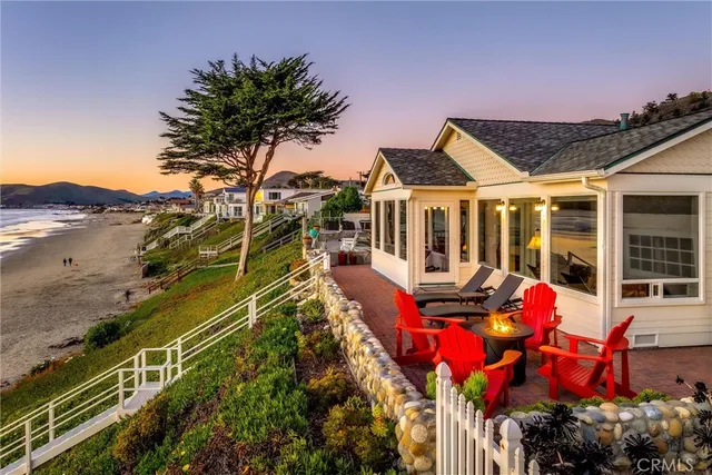 a view of a house with large windows and furniture