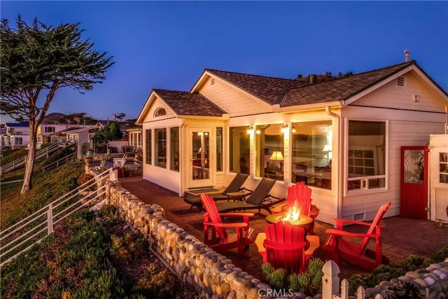 a balcony with outdoor seating and water view