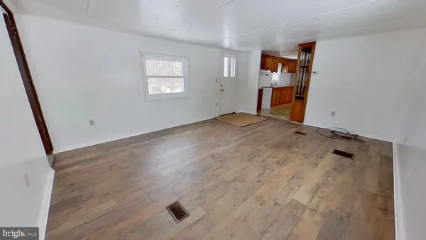 an empty room with closet and windows