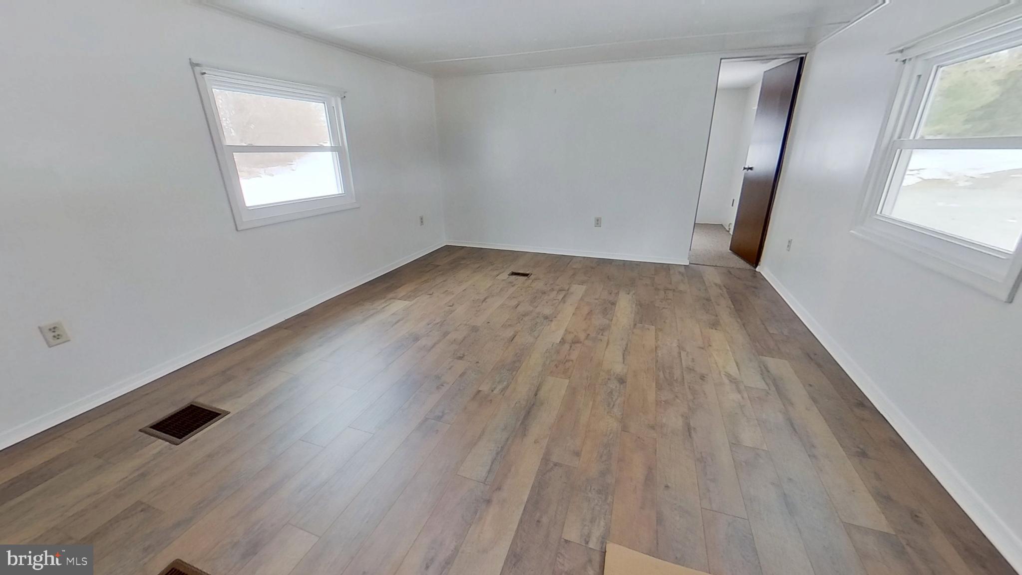 44 Timber Lane Hanover, PA 17331 - Photo 5 of 10 an empty room with wooden floor and windows