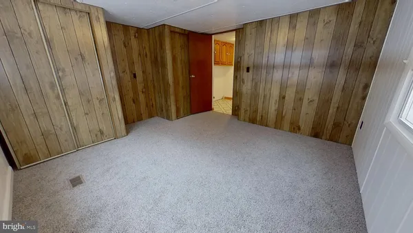 a view of a closet with wooden walls