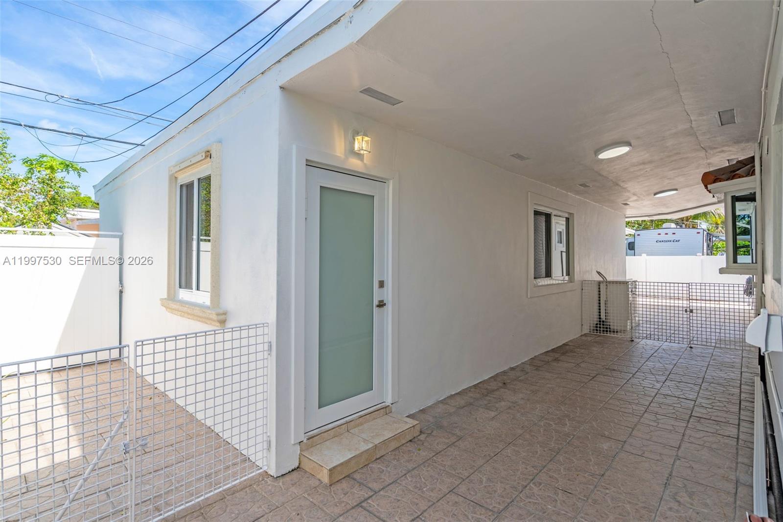 201 Southwest 51st Court, Unit 2 Miami, FL 33134 - Photo 1 of 10 a view of a hallway with wooden floor and a living room
