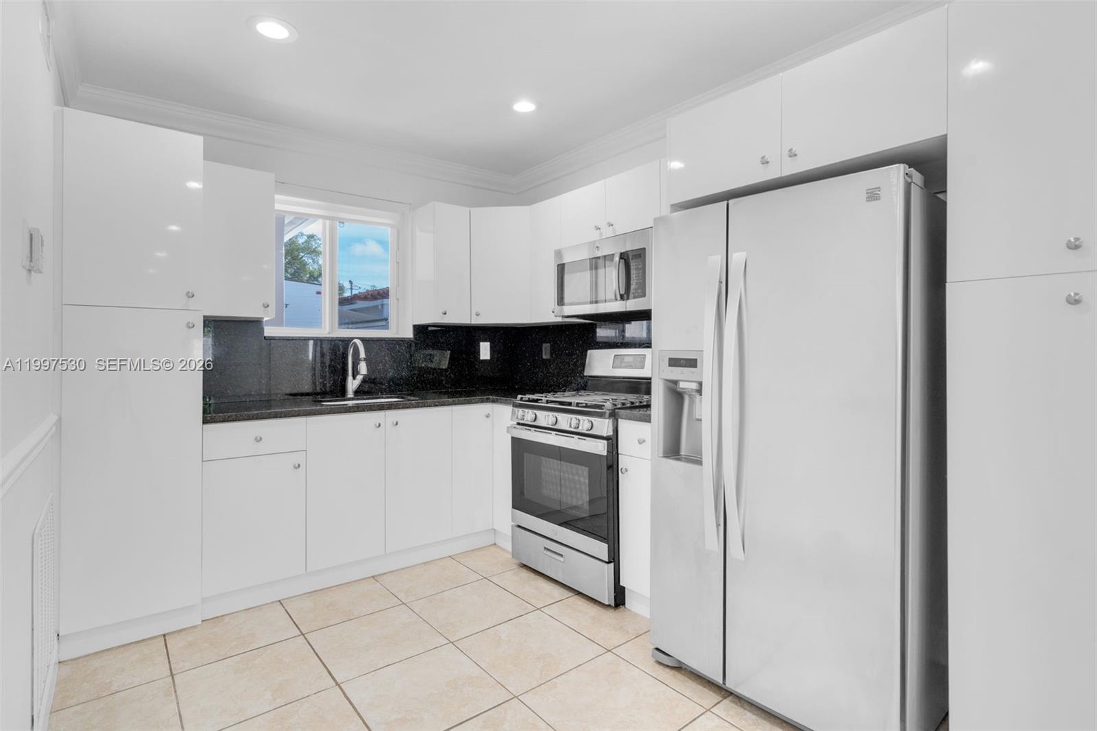 201 Southwest 51st Court, Unit 2 Miami, FL 33134 - Photo 4 of 10 a kitchen with stainless steel appliances a refrigerator sink and microwave