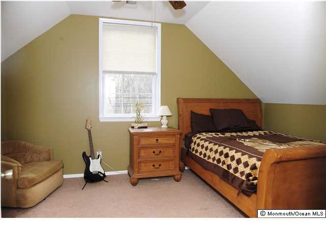 114 Bergerville Road Freehold, NJ 07728 - Photo 13 of 18 a bedroom with a bed and a couch
