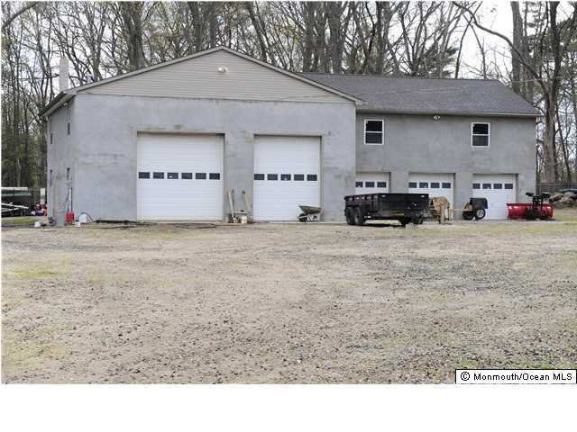 114 Bergerville Road Freehold, NJ 07728 - Photo 17 of 18 a view of a house with a yard and car parked in front of it