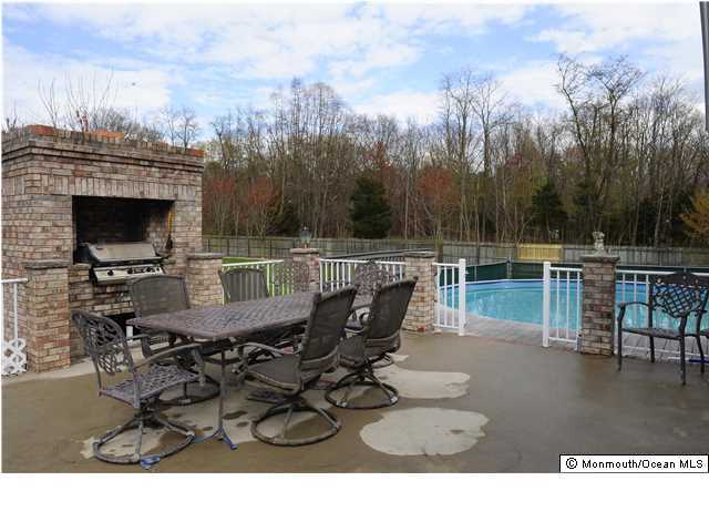 114 Bergerville Road Freehold, NJ 07728 - Photo 5 of 18 a view of a roof deck with table and chairs potted plants with wooden floor