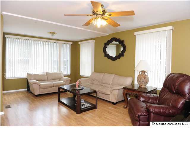 114 Bergerville Road Freehold, NJ 07728 - Photo 8 of 18 a living room with couches and a large window with garden view