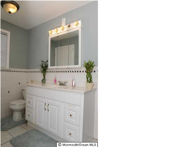 114 Bergerville Road Freehold, NJ 07728 - Photo 9 of 18 a bathroom with a toilet sink and mirror