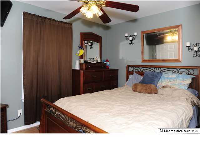114 Bergerville Road Freehold, NJ 07728 - Photo 10 of 18 a bedroom with a bed and a mirror